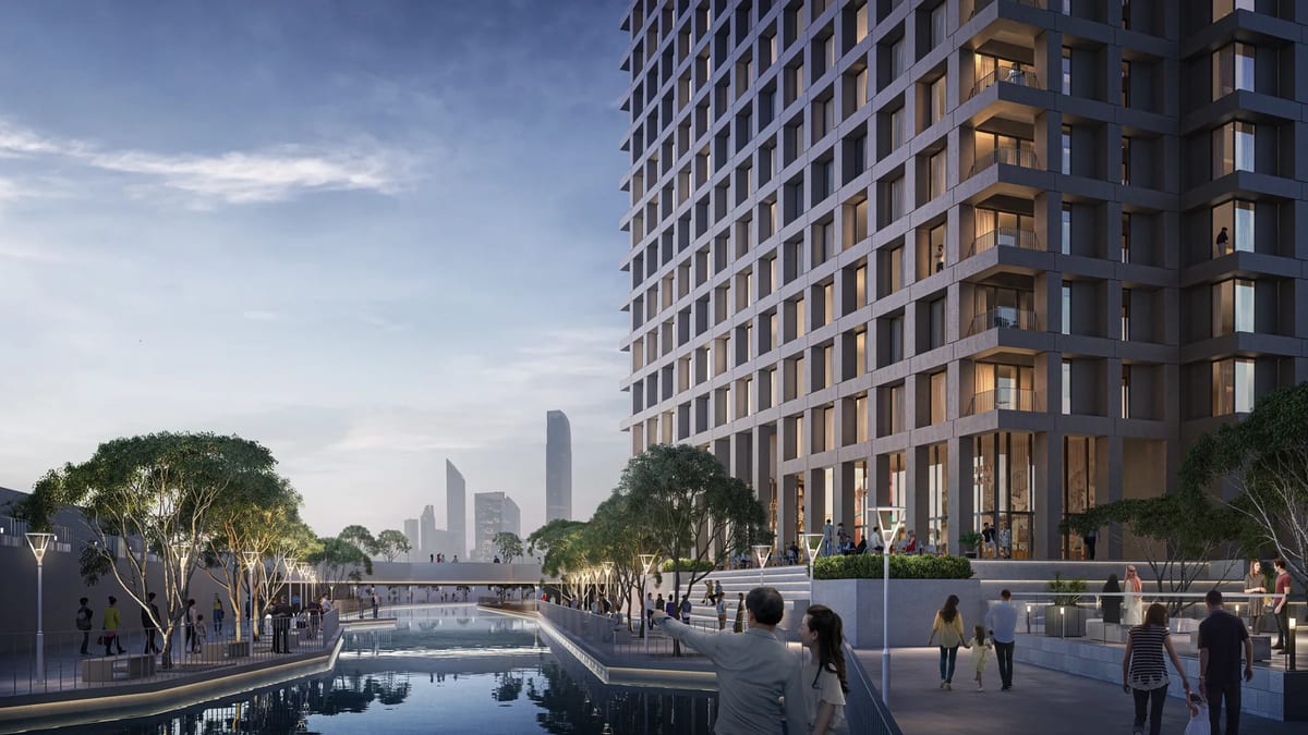Abu Dhabi co-living waterfront courtyard with residential tower, shaded trees, and reflecting pool
