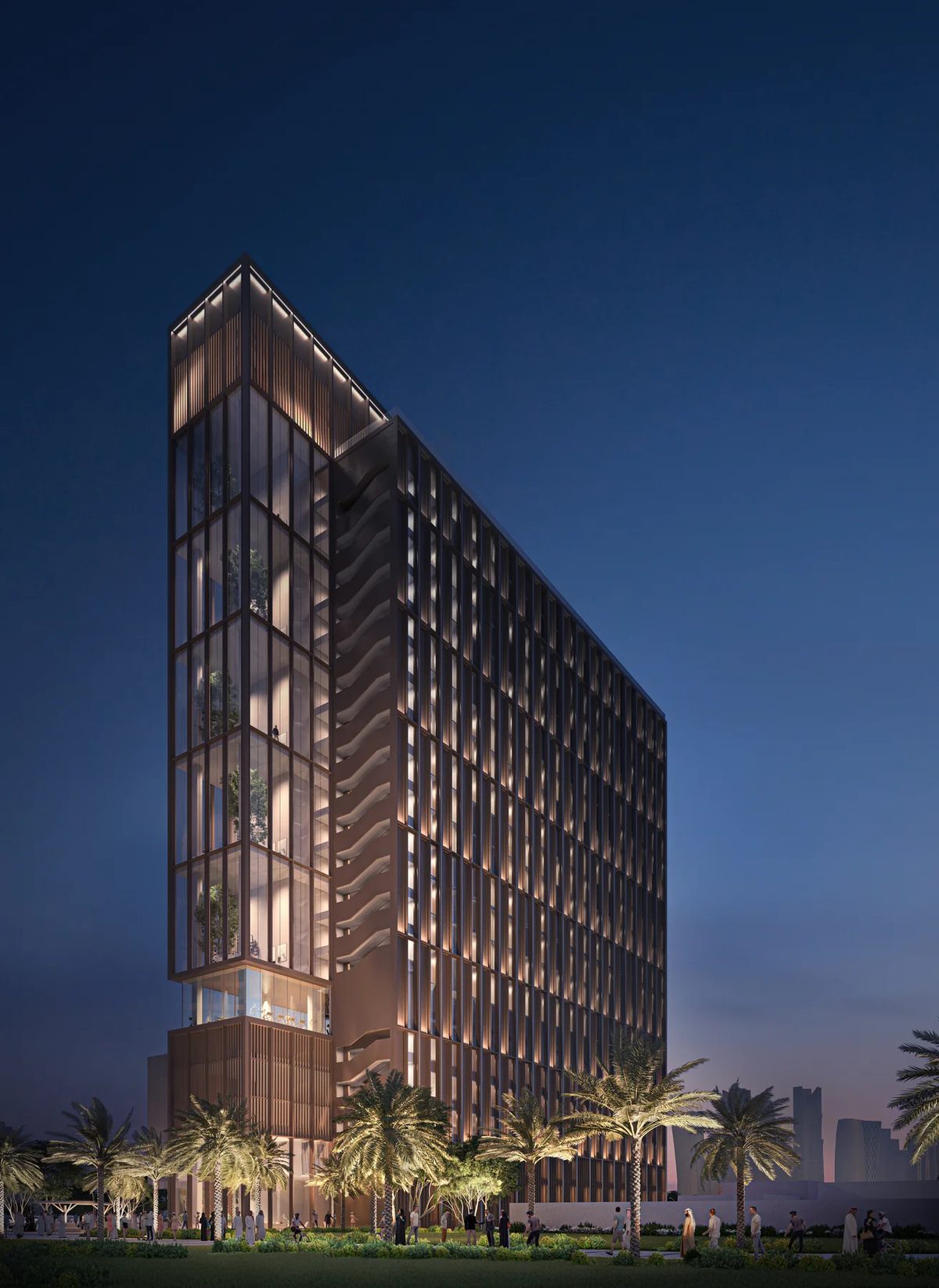 Night view of Abu Dhabi co-living residential tower with illuminated facade and landscaped base