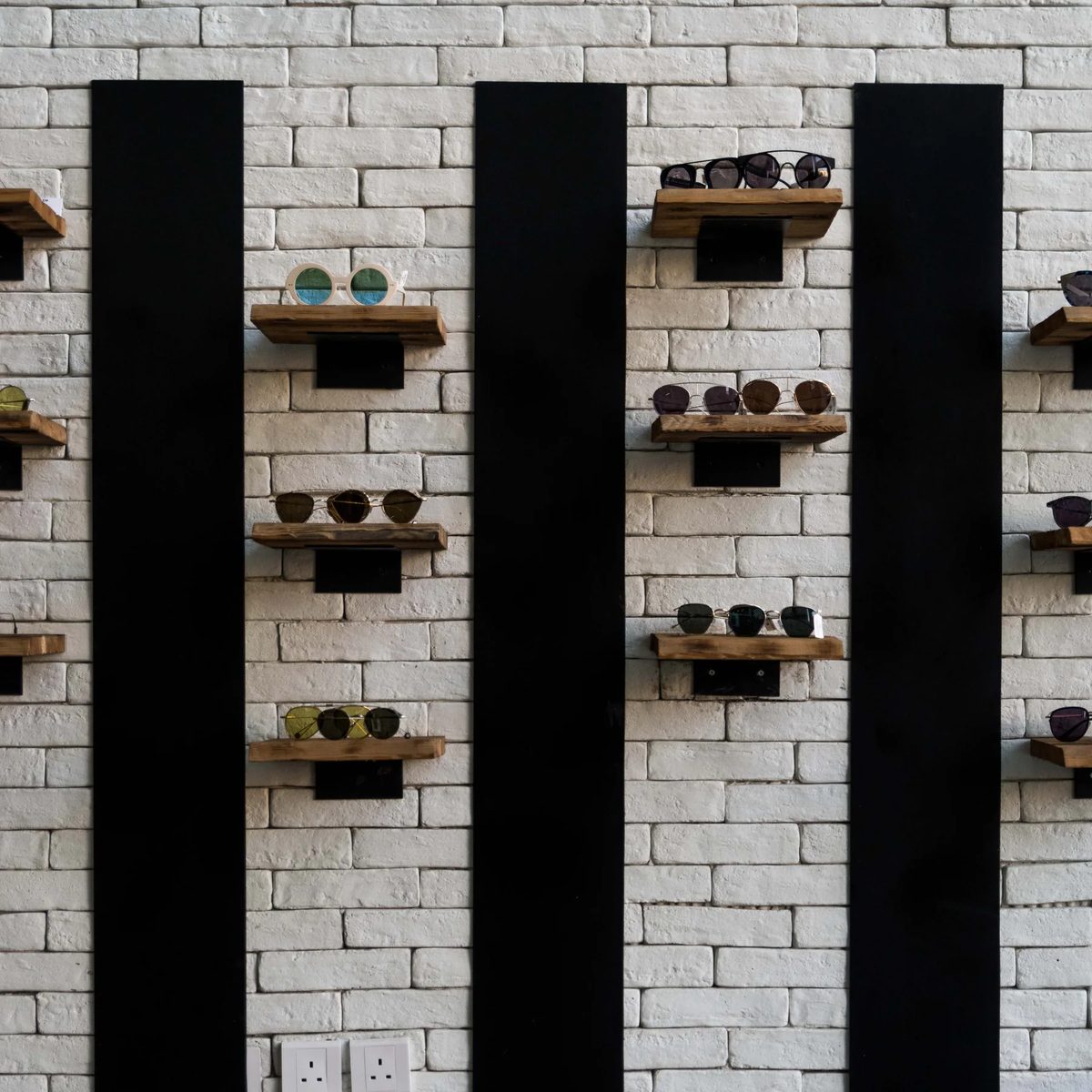 Jamjom retail prototype wall with white block, black steel fins, and timber display shelves