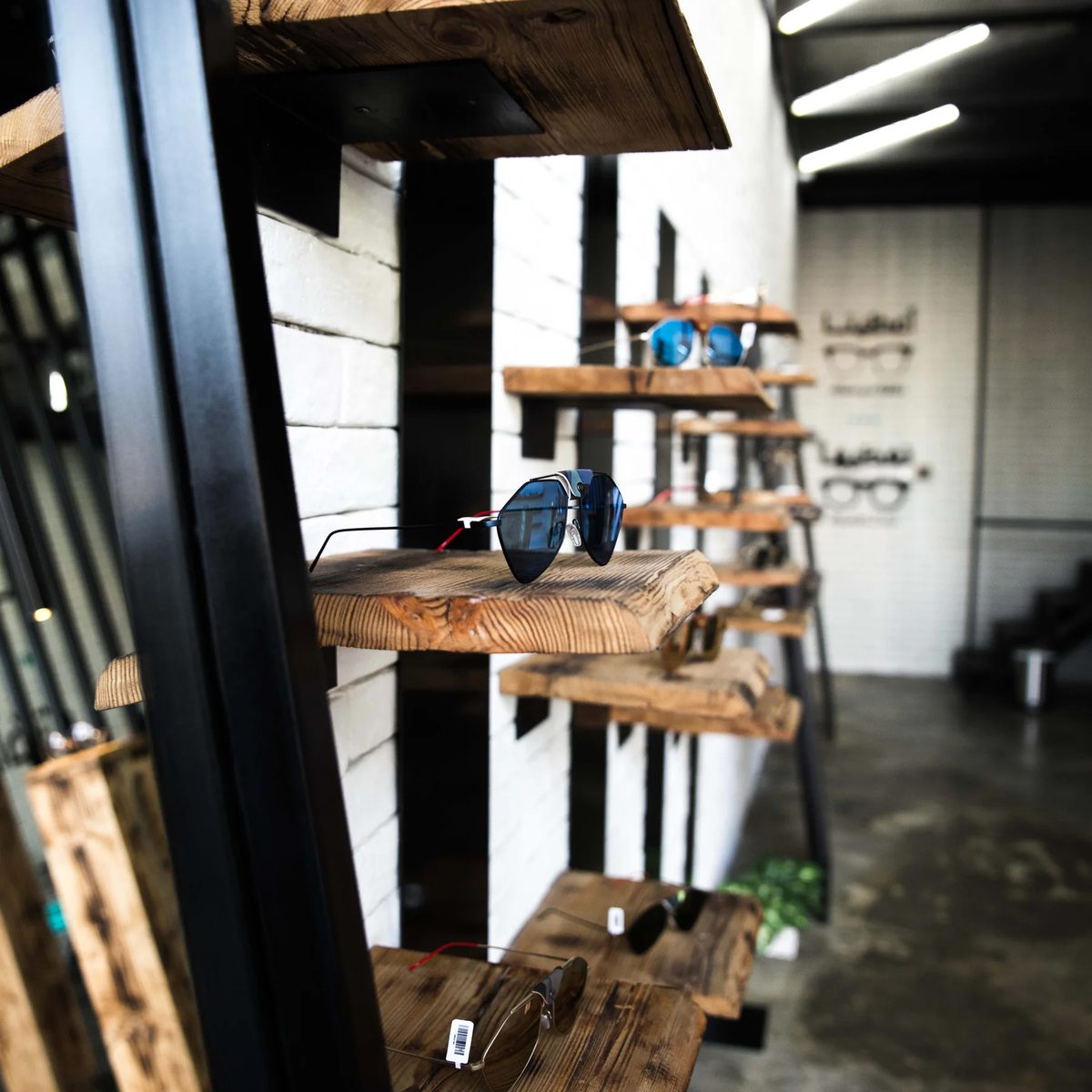Timber retail display shelves set between black steel frames inside Jamjom interior prototype