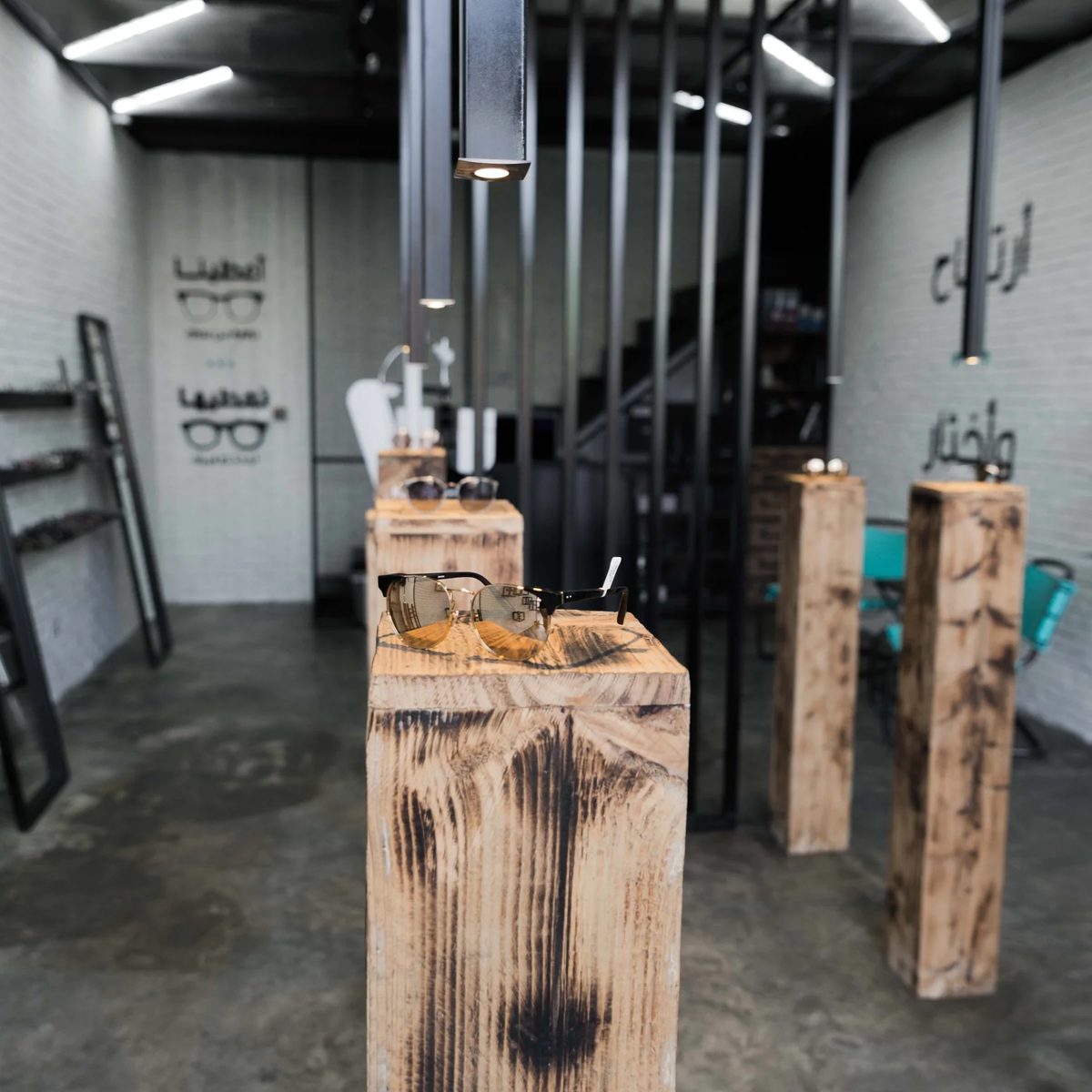Charred timber display plinths and black steel partitions in the Jamjom retail interior