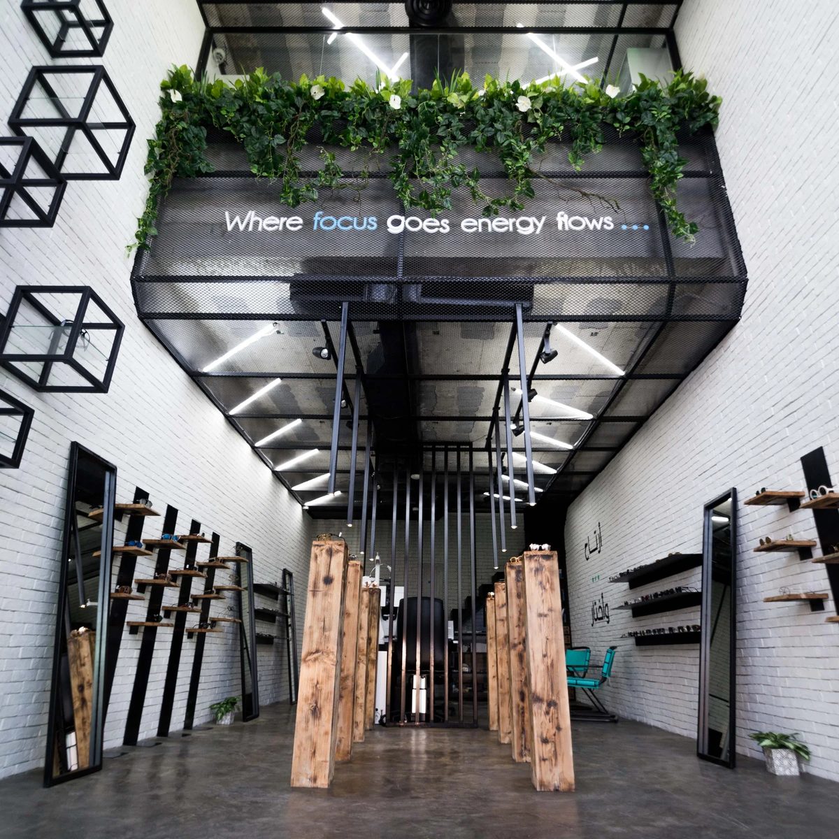 Entry view of Jamjom material prototype with timber blocks, greenery, and linear ceiling lights